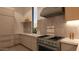 Modern kitchen featuring stainless steel appliances, light-toned cabinets, and marble countertops at 6649 E Ocotillo Rd, Paradise Valley, AZ 85253