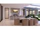 Covered outdoor kitchen and dining area featuring a grill, bar seating, and a dining table at 6649 E Ocotillo Rd, Paradise Valley, AZ 85253