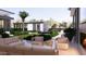 Inviting outdoor lounge area with modern furniture, lush landscaping, and a cozy fireplace at 6649 E Ocotillo Rd, Paradise Valley, AZ 85253