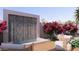 Back patio featuring a modern water feature, a seating area, and lush landscaping at 6649 E Ocotillo Rd, Paradise Valley, AZ 85253