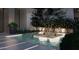 Luxurious water feature showcasing illuminated trees and lush greenery, creating a serene outdoor retreat at 6649 E Ocotillo Rd, Paradise Valley, AZ 85253