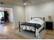 Inviting bedroom featuring a cozy bed with decorative rug, laminate flooring and neutral walls at 703 E Corte Oro --, Phoenix, AZ 85020