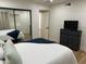 Light-filled bedroom with mirrored closet doors, a sleek dresser and comfortable bedding at 703 E Corte Oro --, Phoenix, AZ 85020