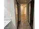 Bright hallway with sliding door closet and tile floors leading to bedrooms with wood flooring at 703 E Corte Oro --, Phoenix, AZ 85020