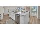 Updated kitchen features a large island with dishwasher, white cabinets, and stainless steel appliances at 703 E Corte Oro --, Phoenix, AZ 85020