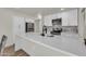 Bright kitchen with stainless steel appliances, white cabinets, subway tile backsplash, and a large island at 703 E Corte Oro --, Phoenix, AZ 85020