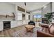 Cozy living room features a fireplace, wet bar, and large windows providing ample natural light at 703 E Corte Oro --, Phoenix, AZ 85020