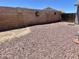 Spacious backyard featuring decorative rock landscaping and a charming block wall at 723 S Weaver Dr, Apache Junction, AZ 85120