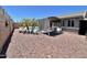 Spacious backyard featuring a pool, patio with pergola, desert landscaping, and privacy wall at 723 S Weaver Dr, Apache Junction, AZ 85120