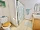 Cozy bathroom featuring a toilet with a wooden seat and a shower with floral curtain at 723 S Weaver Dr, Apache Junction, AZ 85120