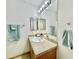 Well-lit bathroom with a vanity, ample lighting, and a large mirror enhancing the space at 723 S Weaver Dr, Apache Junction, AZ 85120