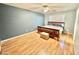 Spacious bedroom featuring wood-look flooring, a ceiling fan, and a large window at 723 S Weaver Dr, Apache Junction, AZ 85120