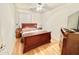 Bedroom featuring hardwood floors, a ceiling fan, and a large window at 723 S Weaver Dr, Apache Junction, AZ 85120
