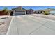 Long driveway leading up to a charming single-story home with low maintenance desert landscaping at 723 S Weaver Dr, Apache Junction, AZ 85120