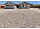Charming single-story home with a two-car garage, desert landscaping, and a cozy front bench at 723 S Weaver Dr, Apache Junction, AZ 85120