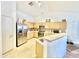 Bright kitchen with light wood cabinets, stainless steel appliances, and tile flooring at 723 S Weaver Dr, Apache Junction, AZ 85120