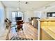 Open floor plan with hardwood floors, seamlessly connects the living and dining areas at 723 S Weaver Dr, Apache Junction, AZ 85120