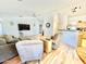 Comfortable seating area with hardwood floors, a large TV, and views into the kitchen at 723 S Weaver Dr, Apache Junction, AZ 85120