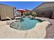 Beautiful backyard pool featuring rock accents, palm trees, and a shady pergola nearby at 723 S Weaver Dr, Apache Junction, AZ 85120