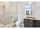 Updated bathroom featuring a glass shower, unique vessel sink, and decorative mirror at 7272 E Gainey Ranch Rd # 117, Scottsdale, AZ 85258