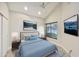 Bedroom with calming decor, vaulted ceiling, and sliding door closet at 7272 E Gainey Ranch Rd # 117, Scottsdale, AZ 85258