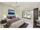 Relaxing bedroom with a ceiling fan, bay window, and calming artwork above the headboard at 7272 E Gainey Ranch Rd # 117, Scottsdale, AZ 85258