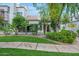 Beautiful exterior of a home with manicured lawn, palm trees, and mature landscaping, perfect for curb appeal at 7272 E Gainey Ranch Rd # 117, Scottsdale, AZ 85258