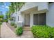 Inviting front entrance with a decorative door, manicured landscaping, and a welcoming pathway at 7272 E Gainey Ranch Rd # 117, Scottsdale, AZ 85258