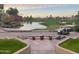 Scenic view of a golf course with a lake and a golf cart, showcasing a premium leisure lifestyle at 7272 E Gainey Ranch Rd # 117, Scottsdale, AZ 85258
