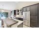 Modern kitchen with stainless steel appliances, stylish cabinets, a breakfast bar, and ample counter space at 7272 E Gainey Ranch Rd # 117, Scottsdale, AZ 85258