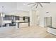 This living room features an open design, vaulted ceiling, modern lighting, and a seamless flow to the kitchen at 7272 E Gainey Ranch Rd # 117, Scottsdale, AZ 85258