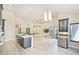 Spacious living room with a modern kitchen featuring stainless steel appliances and a breakfast bar at 7272 E Gainey Ranch Rd # 117, Scottsdale, AZ 85258