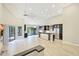 Expansive living room showcasing an open floor plan, modern kitchen, and abundant natural light at 7272 E Gainey Ranch Rd # 117, Scottsdale, AZ 85258