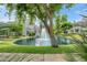 Backyard pond and water feature viewed from home, enhanced by manicured landscaping at 7272 E Gainey Ranch Rd # 117, Scottsdale, AZ 85258