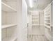 Walk-in closet with adjustable shelving and drawers to maximize organization space at 7272 E Gainey Ranch Rd # 117, Scottsdale, AZ 85258