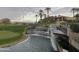 Stunning water feature with tiered waterfalls cascading into a pond, set against a backdrop of a lush golf course at 7272 E Gainey Ranch Rd # 117, Scottsdale, AZ 85258
