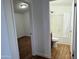 Bathroom with shower over tub and tile surround, and a bedroom on the left at 7300 N 51St Ave # G102, Glendale, AZ 85301
