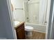 Bathroom features a shower over tub, wood-style flooring, and granite countertop with a modern white basin sink at 7300 N 51St Ave # G102, Glendale, AZ 85301