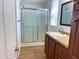 Bathroom view showcasing a glass-enclosed shower and wood cabinetry with granite countertops at 7300 N 51St Ave # G102, Glendale, AZ 85301
