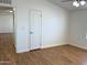 Large bedroom featuring wood-style floors, a ceiling fan, and a white interior door at 7300 N 51St Ave # G102, Glendale, AZ 85301