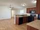 Open kitchen with stainless steel sink, black appliances, and vinyl wood flooring at 7300 N 51St Ave # G102, Glendale, AZ 85301