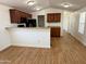 Spacious kitchen with granite countertops, wood cabinets, and vinyl wood flooring at 7300 N 51St Ave # G102, Glendale, AZ 85301