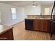 Bright kitchen with granite countertops, stainless steel sink, black dishwasher and vinyl flooring at 7300 N 51St Ave # G102, Glendale, AZ 85301