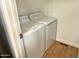Laundry room showcasing a full-size washer and dryer with vinyl wood floors at 7300 N 51St Ave # G102, Glendale, AZ 85301