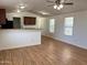 Bright living room with hardwood floors open to the kitchen at 7300 N 51St Ave # G102, Glendale, AZ 85301