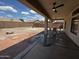 Inviting covered patio with outdoor dining and a spacious backyard with swing at 8006 W Gibson Ln, Phoenix, AZ 85043