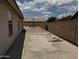Backyard featuring a concrete patio and gravel area with play structure, perfect for outdoor activities at 8006 W Gibson Ln, Phoenix, AZ 85043