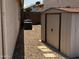 Backyard view of the storage shed and adjacent air conditioning units at 8006 W Gibson Ln, Phoenix, AZ 85043