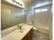 Clean bathroom features tile floors, vanity sink, tub, toilet, and updated fixtures at 8006 W Gibson Ln, Phoenix, AZ 85043