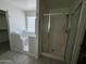 Accessible bathroom features a walk-in tub, glass enclosed shower, and tile flooring at 8006 W Gibson Ln, Phoenix, AZ 85043